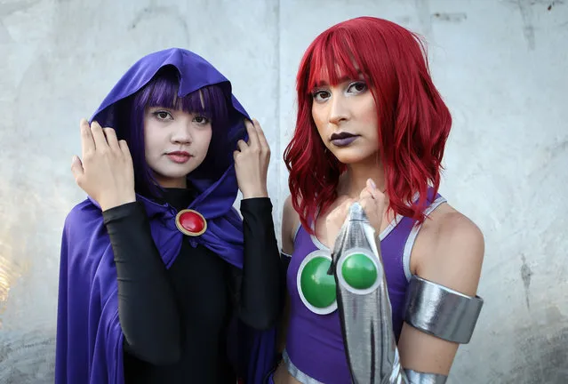 Cosplayers dressed as Starfire and Raven pose outside San Diego Comic-Con on July 20, 2018 in San Diego, California. More than 100,000 are expected at the annual comic and entertainment convention. (Photo by Mario Tama/Getty Images)