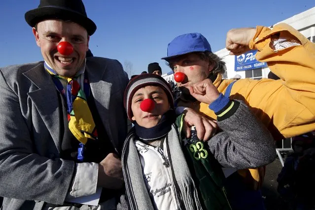 Members of Red Noses Clowndoctors entertain migrants before their departure to Austria at a registration center in Dobova, Slovenia, December 27, 2015. (Photo by Srdjan Zivulovic/Reuters)