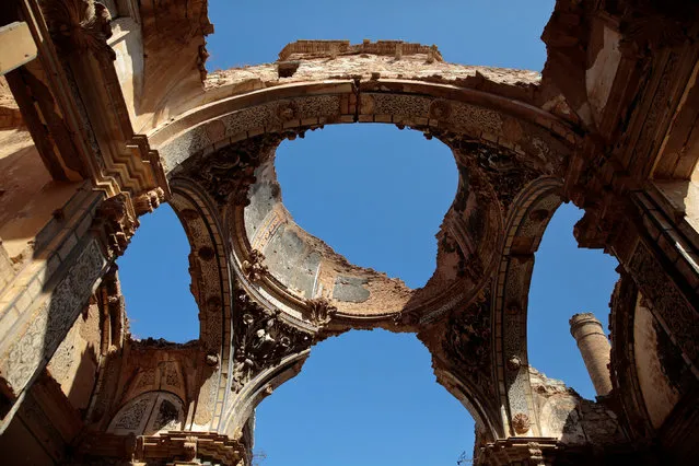 Sky is seen through the holes of the San Agustin church ceiling in the old village of Belchite, in northern Spain, October 3, 2016. (Photo by Andrea Comas/Reuters)