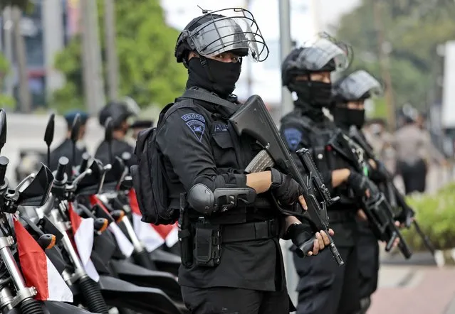 Police officers stand guard near the Association of Southeast Asian Nations (ASEAN) Secretariat ahead of a leaders' meeting in Jakarta, Indonesia, Friday, April 23, 2021. The 10-member Association of Southeast Asian Nations is scheduled to hold a special summit to discuss Myanmar on Saturday. (Photo by Dita Alangkara/AP Photo)