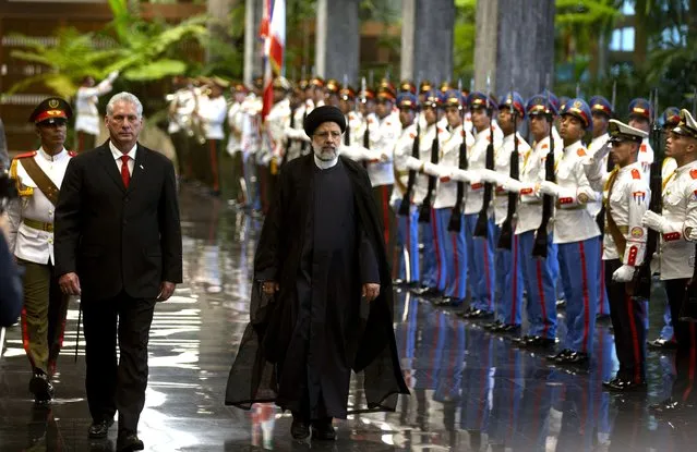 Cuban President Miguel Diaz-Canel, left, and Iran's President Ebrahim Raisi walk past the honor guard during a state visit in Havana, Cuba, Thursday, June 15, 2023. (Photo by Ismael Francisco/AP Photo)