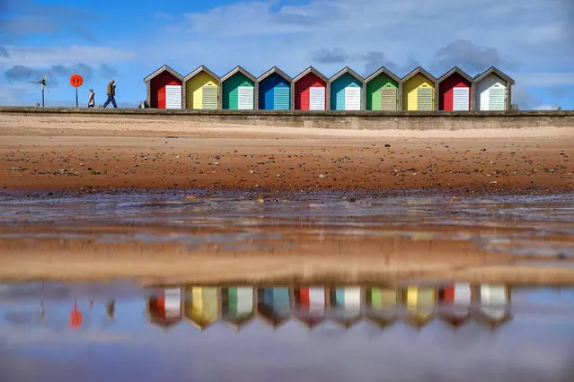 People walk along the sea front at Blyth in Northumberland in North East England on Monday, May 24, 2021. (Photo by Owen Humphreys/PA Images via Getty Images)