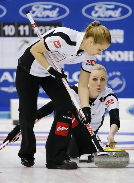 Switzerland's third Nadine Lehmann delivers a stone as her teammate Nicole Schaegli sweeps during their curling round robin game against Japan at the World Women's Curling Championships in Sapporo March 14, 2015. (Photo by Thomas Peter/Reuters)