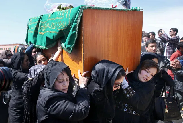 Afghan women rights activists carry the coffin of 27-year-old Farkhunda, an Afghan woman who was beaten to death by a mob, during her funeral, in Kabul, Afghanistan, Sunday, March 22, 2015. Hundreds of people gathered in northern Kabul for the funeral of Farkhunda, who like many Afghans is known by only one name. (Photo by Massoud Hossaini/AP Photo)