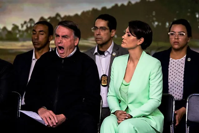 President Jair Bolsonaro yawns as he sits next to his wife first lady Michelle Bolsonaro during an event with business leaders from the poultry and pork sectors in Sao Paulo, Brazil, Tuesday, August 9, 2022. (Photo by Marcelo Chello/AP Photo)