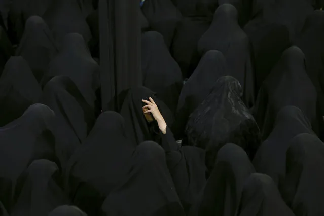 Muslim Shiite women mourn during the holy day of Ashoura, at the Sadat Akhavi Mosque in Tehran, Iran, Thursday, September 20, 2018. Ashoura is the annual Shiite commemoration of the death of Imam Hussein, the grandson of the Prophet Muhammad, at the Battle of Karbala in present-day Iraq in the 7th century. (Photo by Ebrahim Noroozi/AP Photo)