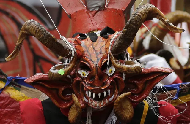 A devil dancer takes part in “La Diablada” festival in Pillaro, Ecuador, Friday, January 6, 2017. Thousands of singing and dancing devils take over a mountain town in Ecuador for six days of revelry in the streets. (Photo by Dolores Ochoa/AP Photo)