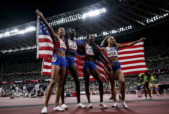 Team United States poses with the flag after winning the Tokyo 2020 Olympic Games 4x400m Women's Relay at Olympic Stadium on Saturday, August 7, 2021. (Photo by Toni L. Sandys/The Washington Post)