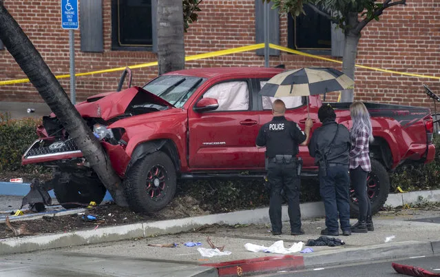 Fullerton Police investigate an early-morning accident that injured several pedestrians, Sunday, February 10, 2019, in Fullerton, Calif. Authorities say a suspected drunken driver was arrested after his pickup truck plowed into a crowd on a sidewalk, injuring multiple people, including some victims who were trapped under the vehicle. (Photo by Mindy Schauer/The Orange County Register via AP Photo)