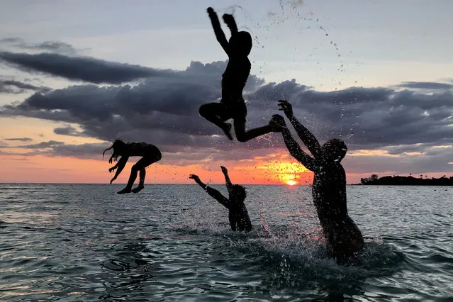 People have fun on a beach during sunset at Ko Kut island in Trat Province, Thailand on October 27, 2018. (Photo by Jorge Silva/Reuters)