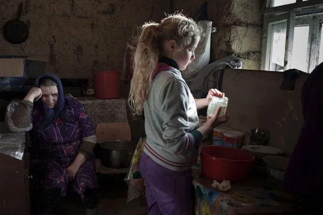 According to the U.S. government, Moldova, one of the poorest countries in Europe, depends on about $1.6 billion annually sent back from the roughly one million Moldovans who left for work in in Europe, Russia, and other former Soviet Bloc countries. Photographer Myriam Meloni went to Moldova to document what she refers to as “social orphans” – children whose parents have emigrated to another country in search of a job and a better future for their families. Here: Lulia is seen washing dishes in her grandmother's house, where she lives. (Photo by Myriam Meloni)