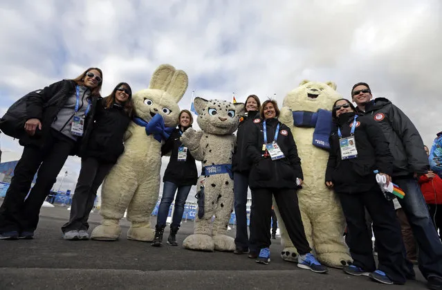 Members of the USA delegation pose for a picture with some mascots during a welcoming ceremony at the 2014 Winter Olympics, Thursday, February 6, 2014, in Sochi, Russia. (Photo by Morry Gash/AP Photo)