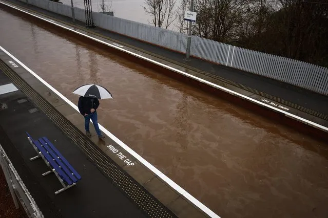 A member of the public is seen on the platform of Bowling station which is shut by flooding on December 27, 2023 in Bowling, Scotland. The Met Office issued yellow wind warnings, with gusts up to 70mph for exposed coastal regions in England, Wales, and Northern Ireland, alongside wintry weather across much of Scotland, marking the seventh named storm in the current UK storm season, spanning September to August next year. (Photo by Jeff J. Mitchell/Getty Images)