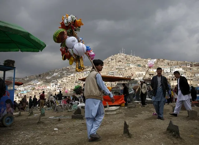 An Afghan man sells toys during  the celebration for Afghan New Year (Newroz) in Kabul, Afghanistan March 20, 2016. (Photo by Ahmad Masood/Reuters)