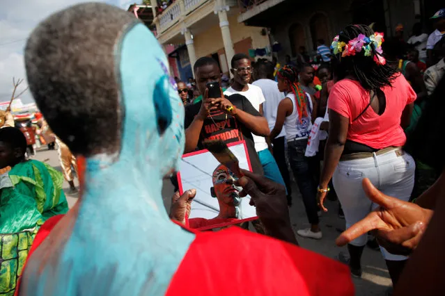 A reveller is reflected in a mirror as he poses for a picture during the Carnival parade in Jacmel, Haiti, February 19, 2017. (Photo by Andres Martinez Casares/Reuters)