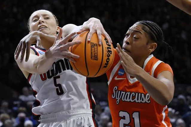 UConn guard Paige Bueckers (5) and Syracuse forward Saniaa Wilson (21) reach for a rebound in the first half of a second-round college basketball game in the NCAA Tournament, Monday, March 25, 2024, in Storrs, Conn. (Photo by Jessica Hill/AP Photo)