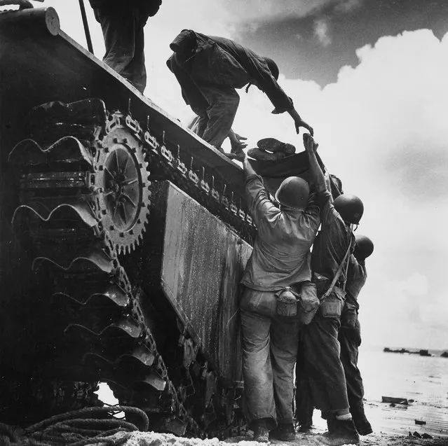 Wounded American Marine being loaded onto an “alligator” tracked amphibious vehicle for evacuation during fighting against Japanese for Asan Point on July 20, 1944. (Photo by W. Eugene Smith/The LIFE Picture Collection/Getty Images)