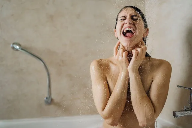 Happy woman enjoying,having a rejuvenating cold shower, singing. Bathroom personal hygiene routine. Antistress. (Photo by Eldar Nurkovic/Alamy Live News)