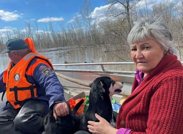 Zulfiya, a sanatorium employee, is evacuated by rescuers from a flooded sanatorium in Orenburg, Russia, on April 13, 2024. (Photo by Alexander Reshetnikov/Reuters)