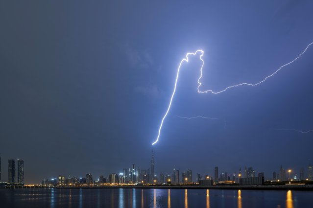 A vicious storm lights up on October 31, 2023 the Burj Khalifa, the tallest building in the world at a cloud-nudging 829.8 metres. (Photo by Vertigodubai/Caters News Agency)