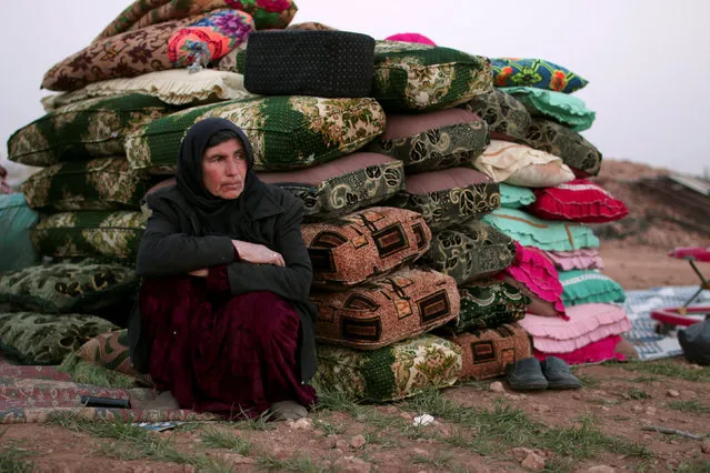 An internally displaced Syrian woman rests near cushions in Manbij city, in Aleppo Governorate, Syria March 9, 2017. (Photo by Rodi Said/Reuters)