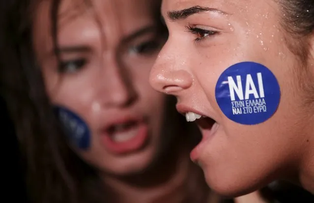 The word “Yes” in Greek is seen on a sticker as pro-Euro demonstrators attend a rally in front of the parliament building, in Athens, Greece, June 30, 2015. Greece's conservative opposition warned on Tuesday that Sunday's vote over international bailout terms would be a referendum over the country's future in Europe, and that wages and pensions would be threatened if people were to reject the package. (Photo by Christian Hartmann/Reuters)
