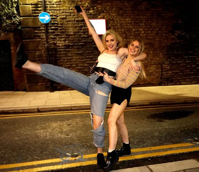 Revellers showed their excitement at being allowed back inside pubs in Leeds in northern England on May 17, 2021, as Covid-19 lockdown restrictions ease. (Photo by Nb press ltd)