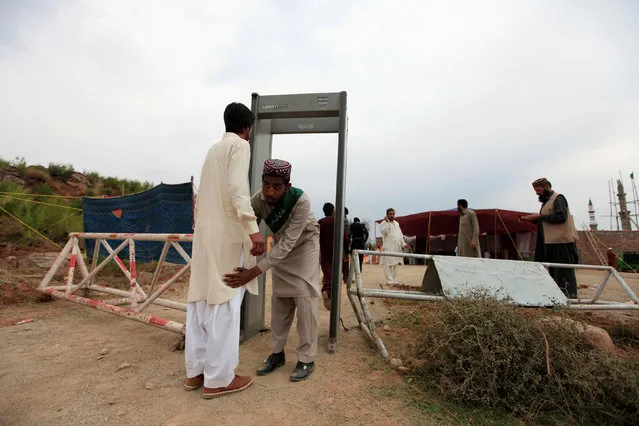 A devotee passes through a security check point at the shrine built over the grave of Mumtaz Qadri, outside Islamabad, Pakistan, February 28, 2017. (Photo by Faisal Mahmood/Reuters)