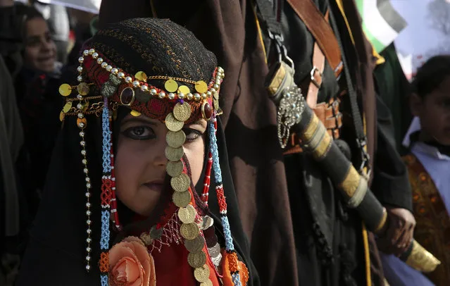 A bedouin girl wears traditional dress attend a rally marking the 41st anniversary of Land Day, in Deir el-Balah, Central Gaza Strip, Friday, March 31, 2017. Land Day commemorates riots on March 30, 1976, when many were killed during a protest by Israeli Arabs whose property was annexed in northern Israel to expand Jewish communities. (Photo by Adel Hana/AP Photo)