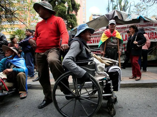 Demonstrators with physical disabilities participate in a rally protest calling on the government to provide a monthly subsidy rather than an annual one in La Paz, Bolivia, May 5, 2016. (Photo by David Mercado/Reuters)