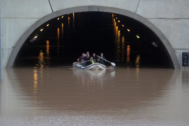 Rescue workers on a boat rescue a person stranded inside a flooded tunnel after heavy floods in Pilar de la Horadada, Spain, September 13, 2019. (Photo by Sergio Perez/Reuters)