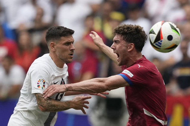 Serbia's Dusan Vlahovic, right, and Slovenia's Erik Janza vie for the ball during a Group C match between Slovenia and Serbia at the Euro 2024 soccer tournament in Munich, Germany, Thursday, June 20, 2024. (Photo by Antonio Calanni/AP Photo)