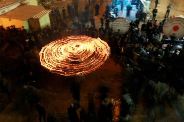 Shi'ite Muslims perform with fire during commemorations for Ashura in Najaf, Iraq on September 7, 2019. (Photo by Alaa Al-Marjani/Reuters)