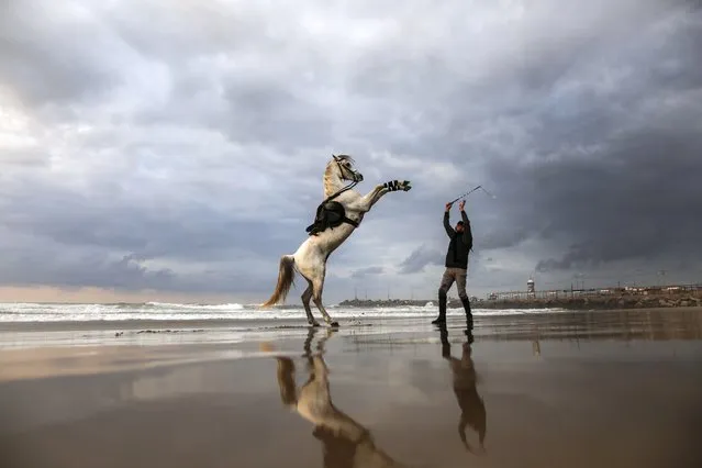 A Palestinian man and his horse take in the sunset on the Gaza beach, on February 26, 2022. (Photo by Sameh Rahmi/NurPhoto via Getty Images)