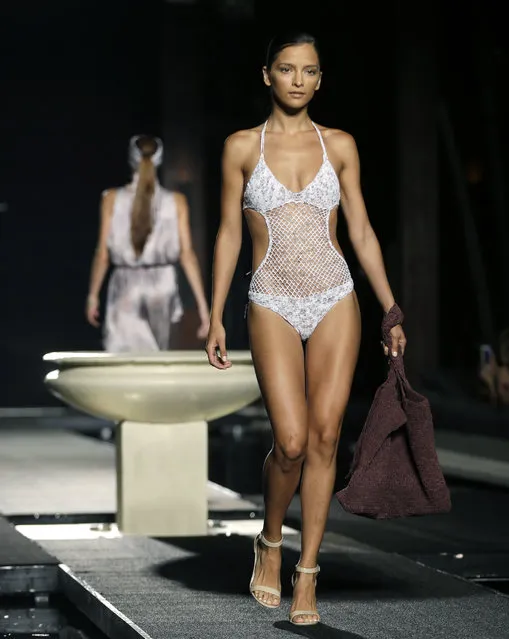 A model walks down the runway during the Sinesia Karol swimwear show as part of Funkshion Fashion Week Swim, Friday, July 17, 2015, in Miami Beach, Fla. (Photo by Lynne Sladky/AP Photo)