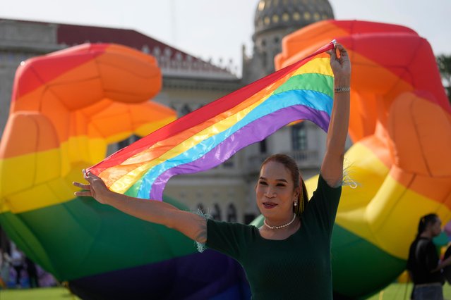 A participant holds a rainbow flag at government house in Bangkok, Thailand, Tuesday, June 18, 2024. Thailand’s Senate voted overwhelmingly on Tuesday to approve a marriage equality bill, clearing the last legislative hurdle for the country to become the first in Southeast Asia to enact such a law. (Photo by Sakchai Lalit/AP Photo)