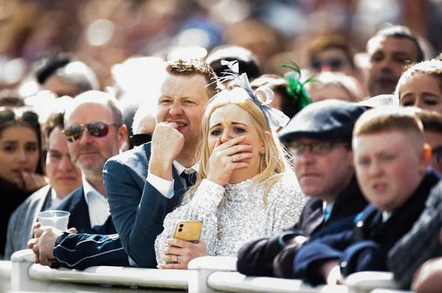 Race goers react after a horse falls and dies infront of the main stand during Grand National Day at the Randox Grand National Festival at Aintree, Liverpool, Britain, 09 April 2022. This year's Grand National is the 174th edition of the legendary annual horse race at the Aintree Racecourse in Liverpool. (Photo by Peter Powell/EPA/EFE)