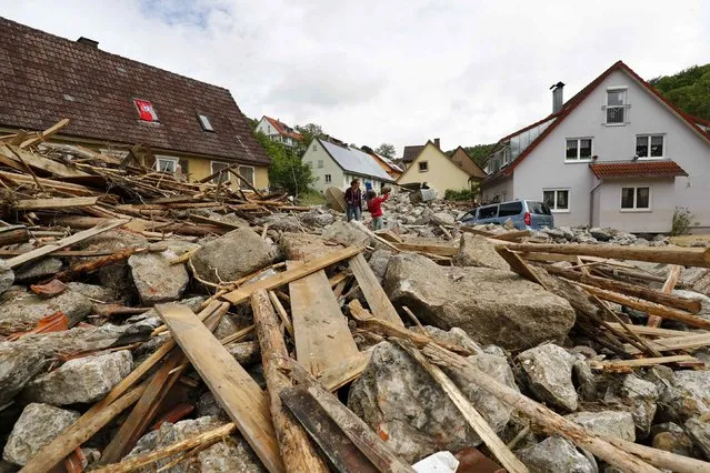 People look at the damage caused by the floods in the town of Braunsbach, in Baden-Wuerttemberg, Germany, May 30, 2016. (Photo by Kai Pfaffenbach/Reuters)