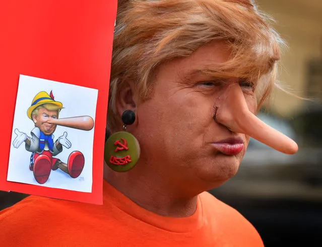 A protester dressed as the President Donald Trump waits for the start of the #ResistMarch during the 47th annual LA Pride Festival in Hollywood, California on June 11, 2017. Inspired by the huge women's marches that took place around the world following the inauguration of President Trump, LA Pride has replaced its decades-old parade with a protest march. (Photo by Mark Ralston/AFP Photo)