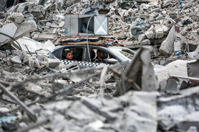 A vehicle moves past the rubble of collapsed buildings in Khan Yunis in the southern Gaza Strip on September 16, 2024, amid the ongoing war in the Palestinian territory between Israel and Hamas. (Photo by Bashar Taleb/AFP Photo)