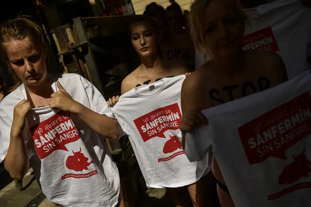 Demonstrators wearing T-shirts reading, “I want a San Fermin without blood” during a protest against bullfighting in front of the City Hall a day before of the San Fermin festival, in Pamplona, northern Spain, Wednesday, July 5, 2017. The festival will begin on July 6 with the “txupinazo” opening ceremony, with people participating in bull runs, music and dance, through the old city. (Photo by Alvaro Barrientos/AP Photo)