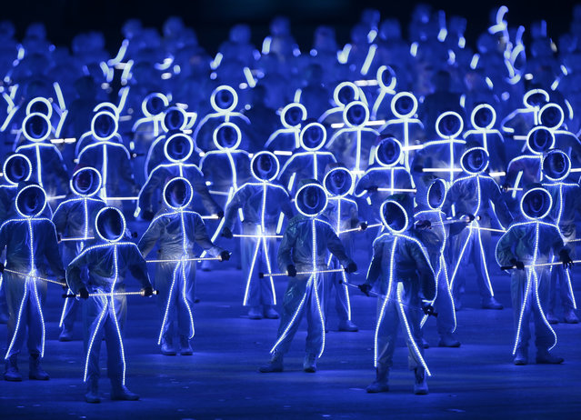 Performers wearing illuminated LED suits on the parade square, called the “Padang”, during the National Day Parade in Singapore, August 9, 2015. The parade features a military column, an aerial flypast titled “Salute to the Nation”, dance performances and ends with a firework display over the Marina Bay. Singapore is celebrating its golden jubilee with a yearlong national campaign titled “SG50” to commemorate its 50th anniversary of independence when the island nation separated from the Federation of Malaysia on 09 August 1965. (Photo by Wallace Woon/EPA)