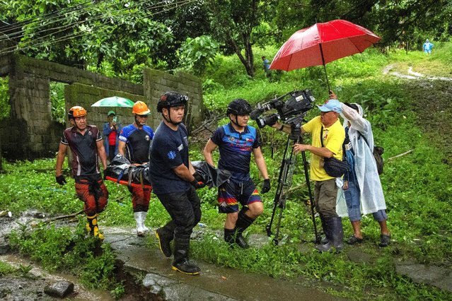 Rescuers carry a body bag with the remains of retrieved landslide victim Rey Ondez, 28, whose house was swept during the Tropical Storm Yagi, locally known as Enteng in San Luis, Antipolo, Rizal province, Philippines, on September 3, 2024. (Photo by Eloisa Lopez/Reuters)