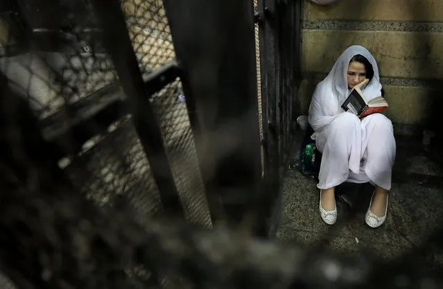 Aya Hijazi, founder of Belady, an NGO that promotes a better life for street children, sits reading a book inside a holding cell as she faces trial on charges of human trafficking at a courthouse in Cairo, Egypt March 23, 2017. (Photo by Mohamed Abd El Ghany/Reuters)