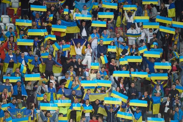 Fans of Ukraine display flags during the UEFA Nations League football match Ukraine v Republic of Ireland in Lodz, Poland on June 14, 2022. (Photo by Radoslaw Jozwiak/AFP Photo)