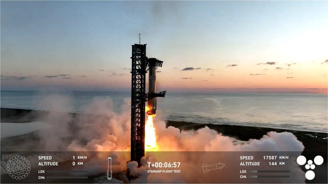 A still image taken from a handout video made available by SpaceX shows SpaceX's “Mechazilla” (L) mechanical arms catching the Super Heavy rocket booster (R) mid-air as it makes a vertical landing following the launch of the unmanned Starship, at SpaceX's Starbase facility in Boca Chica, Texas, 13 October 2024. The successful catching of the booster was the world's first. (Photo by SpaceX/EPA/EFE)