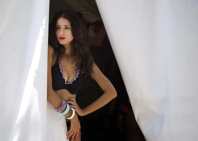 A model waits in a prep tent before walking the runway wearing swimwear from the Gottex collection during the Mercedes-Benz Fashion Week Swim show in Miami Beach, on Jule 20, 2014. (Photo by J. Pat Carter/Associated Press)