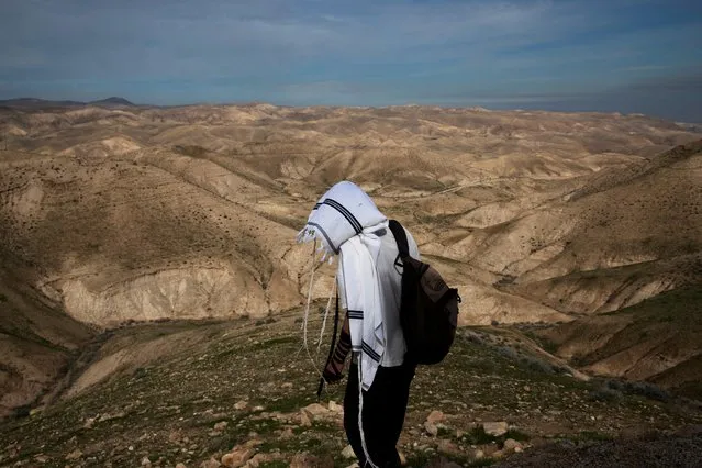 A Jewish shepherd wears a prayer shawl as he stands in the landscape in the Israeli settlement of Mitzpe Yericho in the Jordan Valley in the Israeli-occupied West Bank on January 27, 2020. (Photo by Ronen Zvulun/Reuters)
