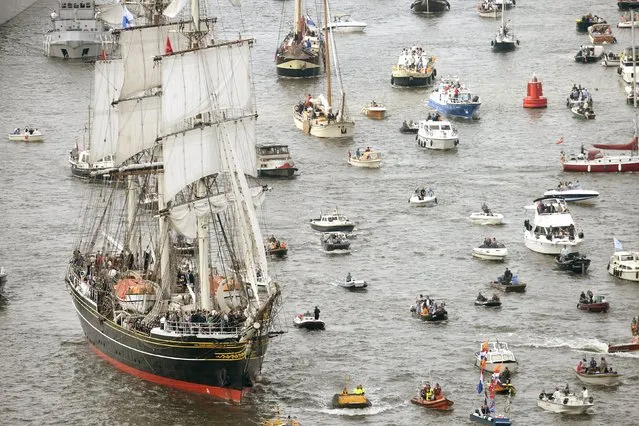 The Stad Amsterdam (L) clipper sails during the Sail-In Parade marking the beginning of the Sail Amsterdam 2015 nautical festival held every five years in Amsterdam, Netherlands August 19, 2015. (Photo by Toussaint Kluiters/Reuters/United Photos)