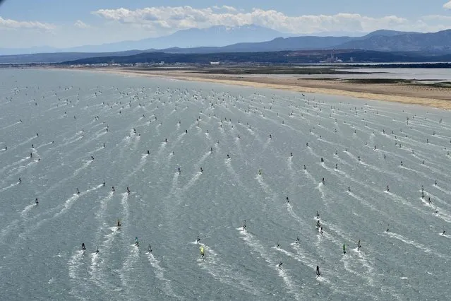 Athletes compete on the third day of the 20th edition of the Defi Wind windsurfing competition in the Mediterranean Sea, off the coat of Gruissan in southern France, on May 28, 2022. Some 1200 windsurfers are taking part in the event. (Photo by Raymond Roig/AFP Photo)